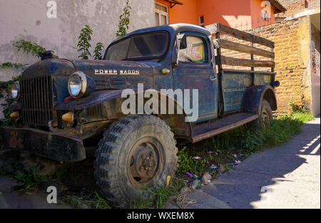 Vecchio Dodge Power Wagon pick-up al di fuori di un garage in un cantiere ricoperta in Perù Foto Stock