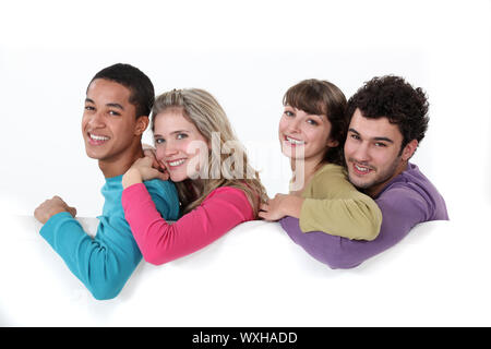 Due coppia giovane si presentò da poster in bianco Foto Stock