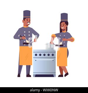 I cuochi giovane chef professionisti utilizzando padella agitazione cibo americano africano uomo donna ristorante cucina lavoratori in uniforme insieme in piedi vicino a Illustrazione Vettoriale