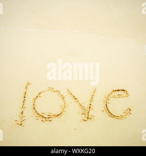 Scritto a mano amore sulla sabbia e la spiaggia Foto Stock