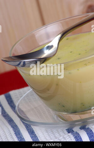 Brokkoli minestra in crema in una ciotola con un cucchiaio Foto Stock