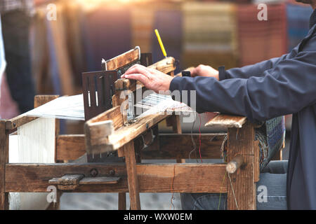 Il vecchio telaio di legno durante una tessitura Foto Stock