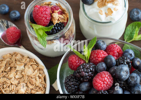 Sana colazione con prodotti freschi lo yogurt greco, fiocchi e bacche Foto Stock