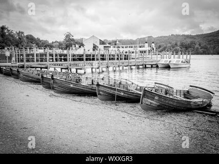 Bianco nero fotografia di porto, warf, marina, shore con barche di legno. Lake District, Foto Stock