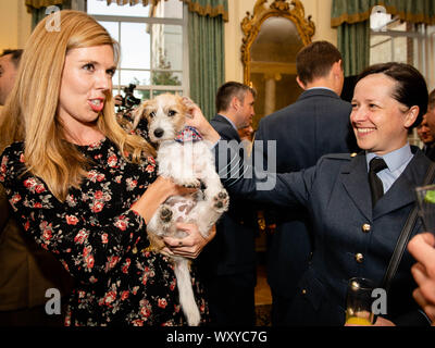 Il partner del primo ministro Boris Johnson, Carrie Symonds (a sinistra), presenta gli ospiti a Dilyn The Jack Russell, il loro cane, come il primo ministro ospita un'accoglienza militare al 10 Downing Street, Londra. Foto Stock
